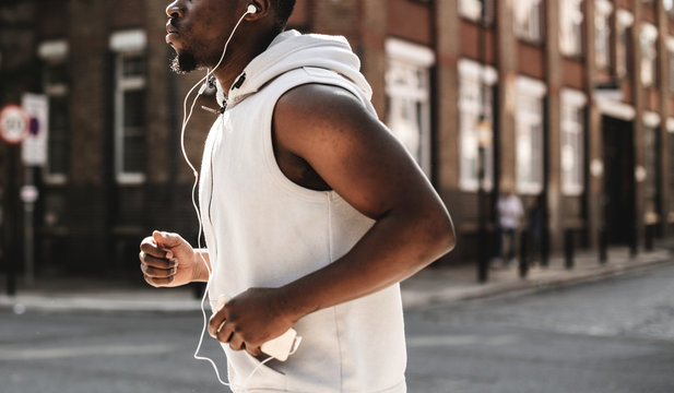 Athletic Man Running With Earphones