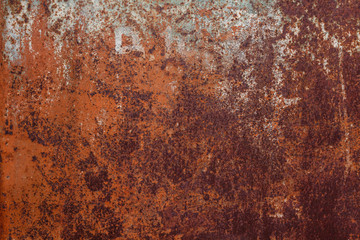 Rusty yellow-red textured metal surface. The texture of the metal sheet is prone to oxidation and corrosion. Textured background in grunge Style
