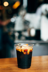 A glass of drink on a wooden table