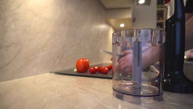 Father is cooking, father prepares fresh organic tomatoes and garlic for chopping