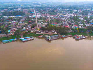 Fototapeta na wymiar top view of drone camera of Laos transportation boats parking at golden triangle port of Chiang saen,Chiang rai,Thailand
