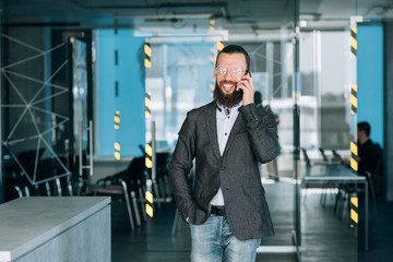 smiling man talking on the phone. communication and successful business deals