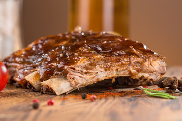 Delicious barbecued ribs seasoned with a spicy basting sauce and served with chopped fresh...