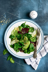 Vegetable salad with beetroot, spinach, apple and walnut.Top view with copy space.