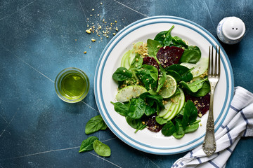 Vegetable salad with beetroot, spinach, apple and walnut.Top view with copy space.