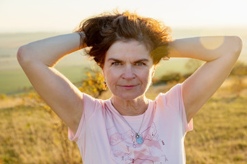 Woman in the nature at sunset