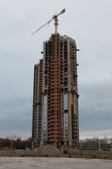 Fototapeta premium Construction of the building in bad weather. Concept of the difficulty of doing business