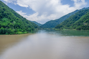 view of the confluence of two rivers, mountains