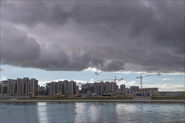 Fototapeta premium construction of new residential buildings of the waterfont