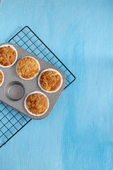 Fresh baked muffins on bright blue background