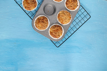 Fresh baked muffins on bright blue background