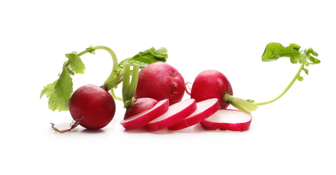 Fresh red radishes with leaves isolated on white background