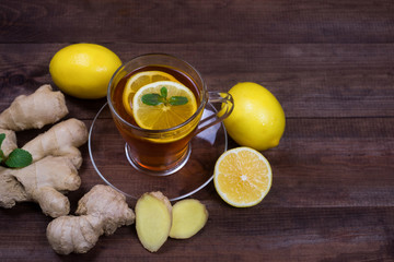 Ginger tea with lemon and &nbsp;mint on a wooden table.The concept of health.Drink rich of vitamins for winter time in cold days.