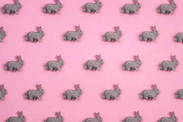 Creative and minimal pattern made of rabbits. Pink background. Flat lay top view.