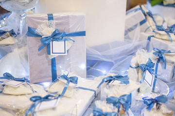 Wedding favor decorated with lace and blue ribbon with message in a bottle with white labels ready to personalize with your text