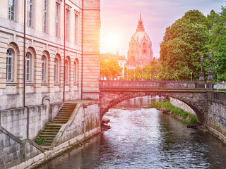 River Leine in Hanover city. City Hall background. View at sunset - obrazy, fototapety, plakaty