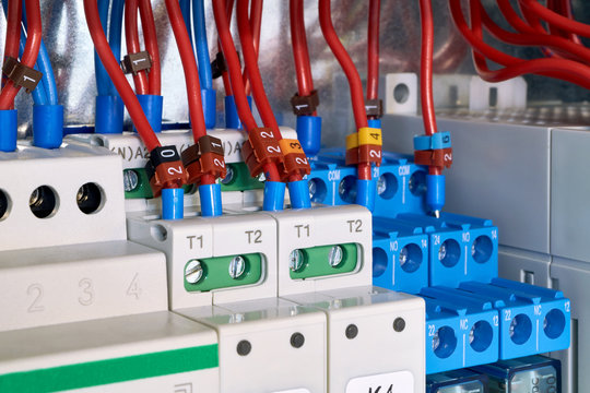 The electrical wires are connected to the intermediate relays and control devices. The cables are marked with numbers. Modern technologies in electrical and technical production.