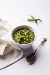 Healthy Indian Green Chutney or Sauce Made using Coriander, Mint And Spices. isolated over moody background. Selective focus