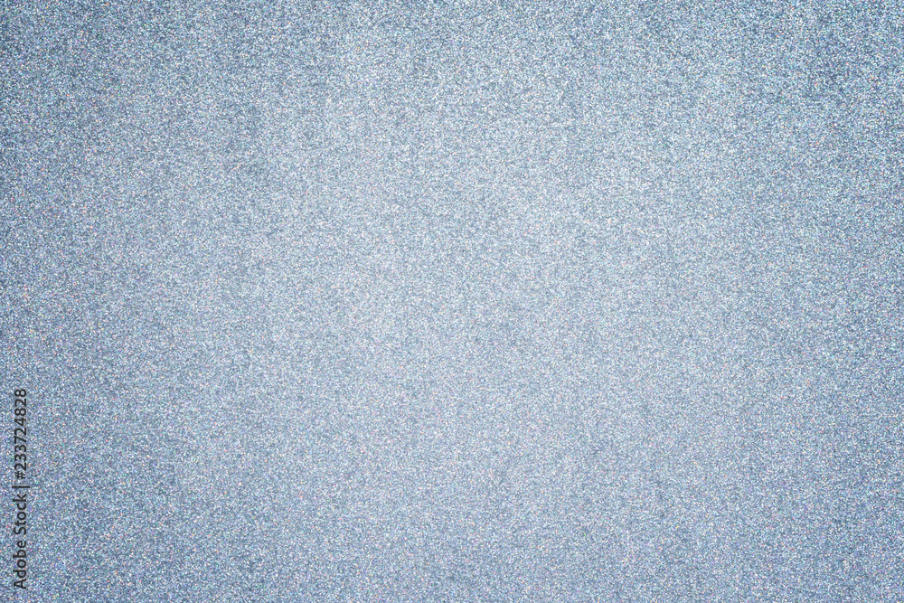 Poster silver glitter full frame textured shiny abstract background with vignetting.
