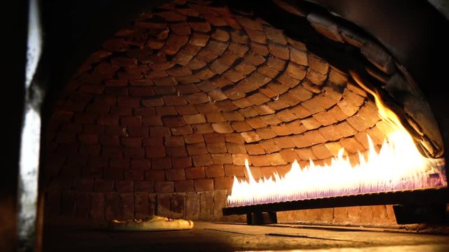 cooking pizza in a stone oven