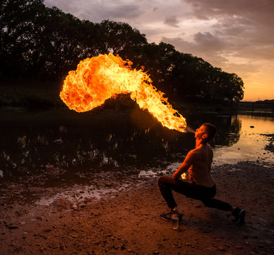  Fire-eater blowing a large flame from his mouth