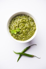 Healthy Indian Green Chutney or Sauce Made using Coriander, Mint And Spices. isolated over moody background. Selective focus