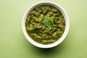 Healthy Indian Green Chutney or Sauce Made using Coriander, Mint And Spices. isolated over moody background. Selective focus