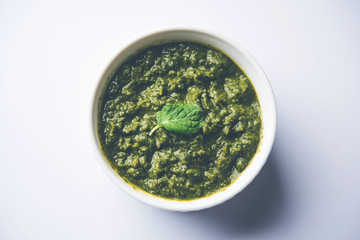 Healthy Indian Green Chutney or Sauce Made using Coriander, Mint And Spices. isolated over moody background. Selective focus