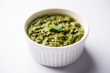 Healthy Indian Green Chutney or Sauce Made using Coriander, Mint And Spices. isolated over moody background. Selective focus