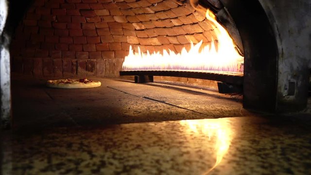 cooking pizza in a stone oven