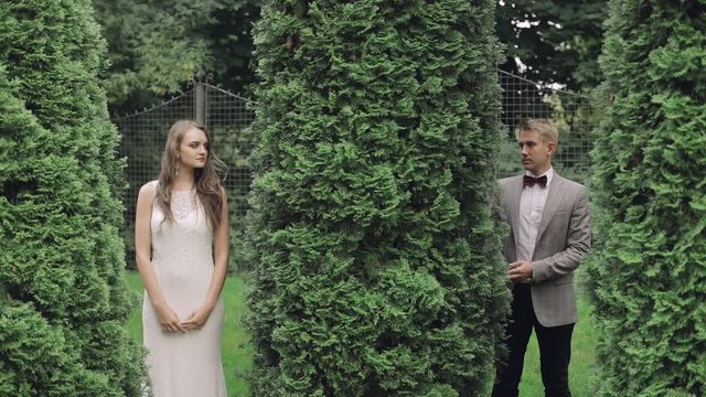 Young and beautiful wedding couple together in the park. Lovely groom and bride. Wedding day. Slow motion