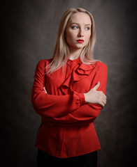 Portrait of a young woman in a red blouse.