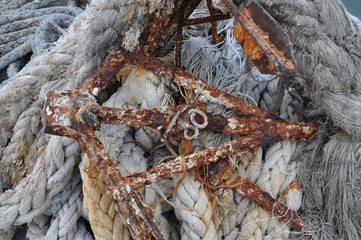 Rusty anchor and old rope.