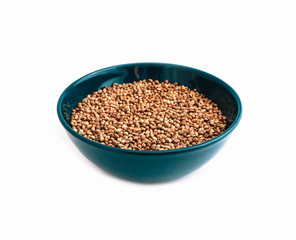 Cannabis seeds in a blue bowl, isolated on white background. Marijuana grains in a plate, herbal health treatment.
