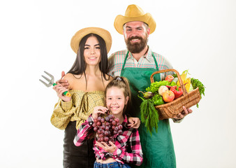Parents and daughter farmers celebrate harvest holiday. Family rustic style farmers proud of fall harvest. Family farmers gardeners basket harvest isolated white background. Harvest festival concept