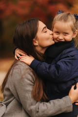 Two sisters walk in the park in autumn time. Childhood. season and people consept-happy family. Portrait of happy sisters in forest