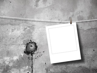 Blank square instant photo frame against concrete wall background