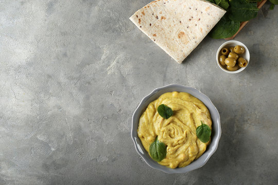 Plate With Tasty Hummus And Flatbread On Grey Table