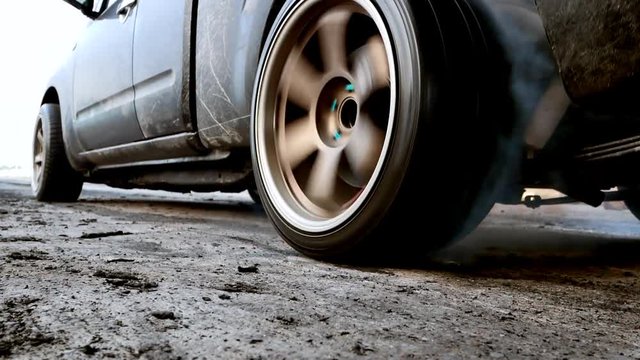 Drag car make tires warm up with smoke, Car racing burnout rubber off its tires in preparation for the race.