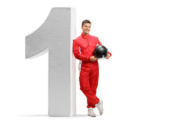 Racer leaning against big sized number one and holding a helmet © Ljupco Smokovski