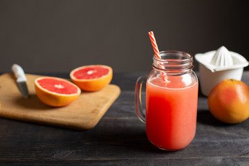 Freshly squeezed grapefruit juice in a jar with a handle.