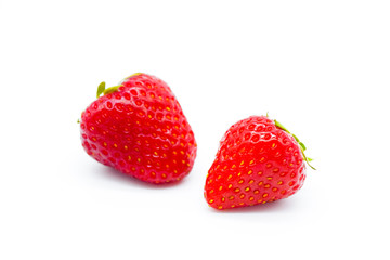 Two whole strawberries isolated on white background