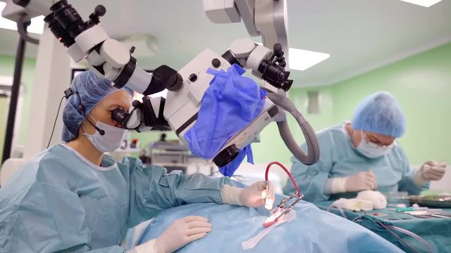 doctors are performing operation on human ear is using powerful stereo microscope in ENT clinic
