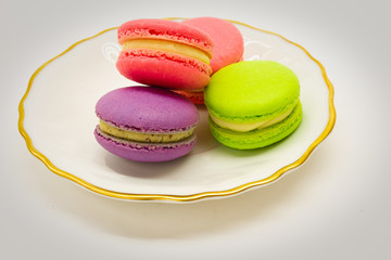 Macarons on a plate. White background