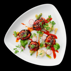 Asian style vegetable appetizer isolated on black