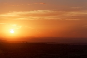 Fototapeta premium Sunset with mountain silhouette and clouds