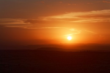 Sunset with mountain silhouette and clouds