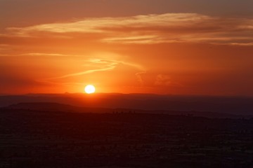 Sunset with mountain silhouette and clouds