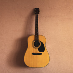 Fototapeta na wymiar old acoustic guitar on a sandy texture. sunlight.