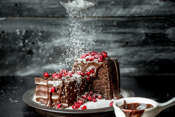 sweet moments - brownies poured hot, liquid chocolate, sprinkled with red pomegranate seeds and powdered sugar
